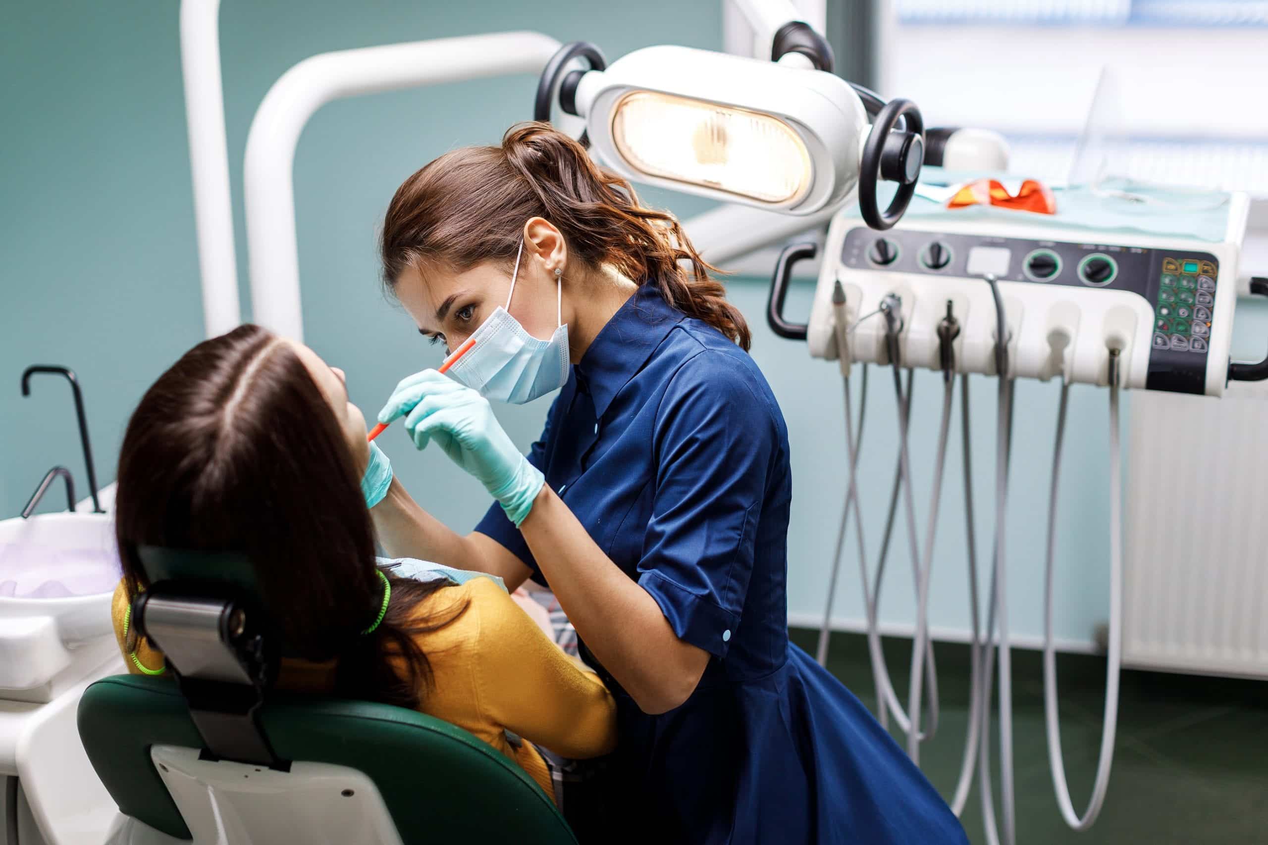 Doctor checking teeth of black man